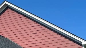 Poorly installed James Hardie siding that is lifting off of the house.
